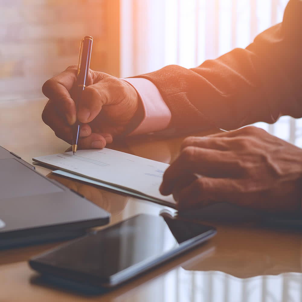 Man reviewing and signing documents